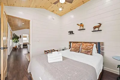 a bedroom with a bed and a wooden ceiling at The Lodges at Eden Reserve - Back Cabins - Near Ark in Williamstown
