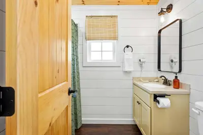 a bathroom with a sink and a mirror at The Lodges at Eden Reserve - Cabin Loop - Near Ark in Williamstown