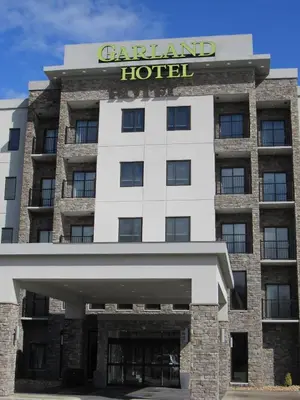 a large hotel with a sign on top of it at Garland Hotel in New Concord