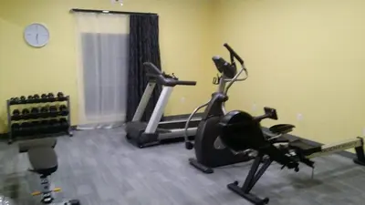 a gym with two exercise bikes in a room at Garland Hotel in New Concord