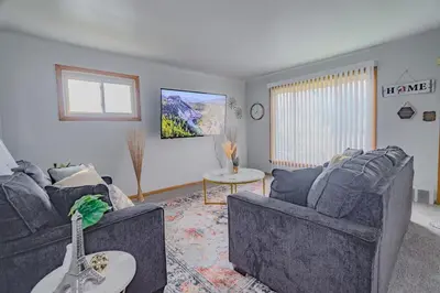 a living room with two couches and a guitar at 3 bedrooms at Cleveland in Euclid