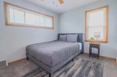a bedroom with a bed and two windows at 3 bedrooms at Cleveland in Euclid