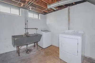 a bathroom with a sink and a washing machine at 3 bedrooms at Cleveland in Euclid