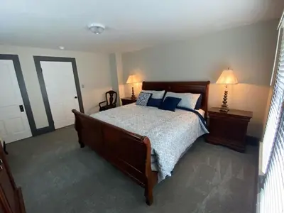 a bedroom with a large bed with blue pillows at London Maisonette - Red Door in London