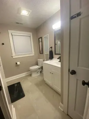 a bathroom with a toilet and a sink and a mirror at London Maisonette - Red Door in London