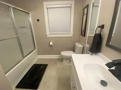 a bathroom with a toilet and a sink and a shower at London Maisonette - Red Door in London