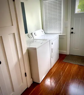 a white washer and dryer in a room at London Maisonette - Black Door in London