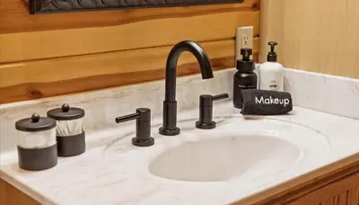 a bathroom counter with a sink with a sink at Trails End Cabin- Sauna, Arcade, Hot Tub, Firepit in Logan
