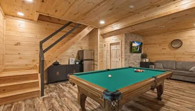a living room with a pool table in a cabin at Trails End Cabin- Sauna, Arcade, Hot Tub, Firepit in Logan