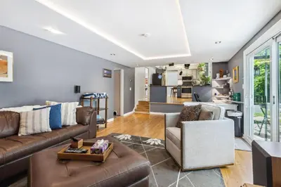 a living room with a couch and a table at Spacious Family Getaway- Salt Water Pool & Hot Tub in Lyndhurst