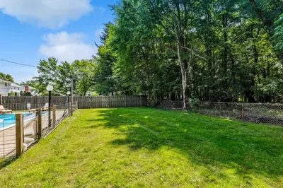 a yard with a fence and a pool at Spacious Family Getaway- Salt Water Pool & Hot Tub in Lyndhurst