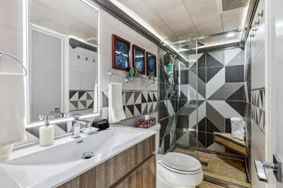 a bathroom with a sink and a toilet at Spacious Family Getaway- Salt Water Pool & Hot Tub in Lyndhurst