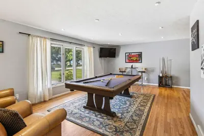 a living room with a pool table in it at Spacious Family Getaway- Salt Water Pool & Hot Tub in Lyndhurst