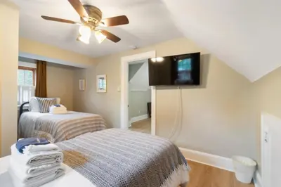 a bedroom with two beds and a flat screen tv at Spacious 3 bed 2 and a half bath 2pk spot in Cincinnati