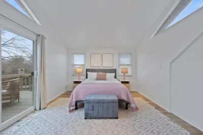 a bedroom with a bed and a balcony at Green Destiny! 7min to DT Cincy, Pool & Hottub in Ludlow