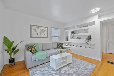 a living room with a couch and a table at Green Destiny! 7min to DT Cincy, Pool & Hottub in Ludlow