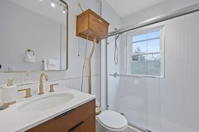 a bathroom with a sink and a toilet and a mirror at Green Destiny! 7min to DT Cincy, Pool & Hottub in Ludlow