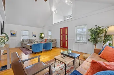 a living room with a couch and a table at Green Destiny! 7min to DT Cincy, Pool & Hottub in Ludlow