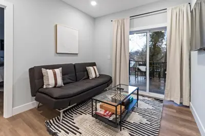 a living room with a black leather couch at Oakley Gold Std New Construc 4king bed 4ens bthrm in Cincinnati