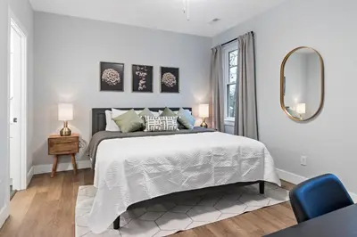 a white bedroom with a bed and a mirror at Oakley Gold Std New Construc 4king bed 4ens bthrm in Cincinnati