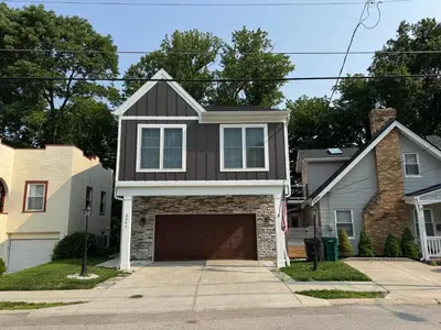 a house with a black roof and a garage at Oakley Gold Std New Construc 4king bed 4ens bthrm in Cincinnati