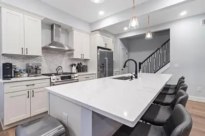 a kitchen with white cabinets and a white counter top at Oakley Gold Std New Construc 4king bed 4ens bthrm in Cincinnati