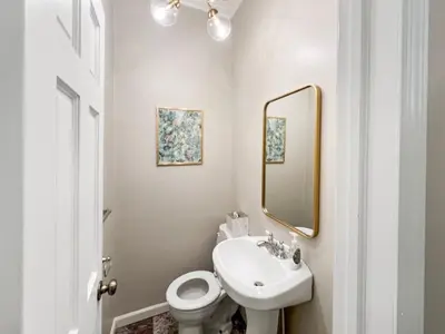 a bathroom with a sink and a toilet and a mirror at Cute & Cozy 2 bed 1 and a half bath Oakley in Cincinnati