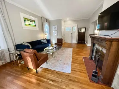 a living room with a blue couch and a fireplace at Cute & Cozy 2 bed 1 and a half bath Oakley in Cincinnati