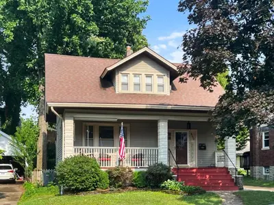 a house with a flag in the front yard at Cute & Cozy 2 bed 1 and a half bath Oakley in Cincinnati