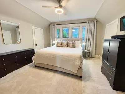 a bedroom with a bed and a large window at Cute & Cozy 2 bed 1 and a half bath Oakley in Cincinnati