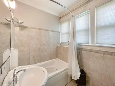 a bathroom with a sink and a bath tub at Cute & Cozy 2 bed 1 and a half bath Oakley in Cincinnati