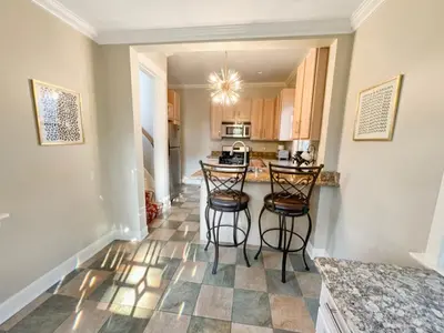 a kitchen with two bar stools and a counter top at Cute & Cozy 2 bed 1 and a half bath Oakley in Cincinnati