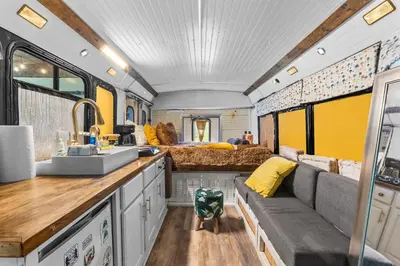 a kitchen and living room in a recreational vehicle at Covered Bridge Tiny Home Bus On The Water In Rrg in Stanton