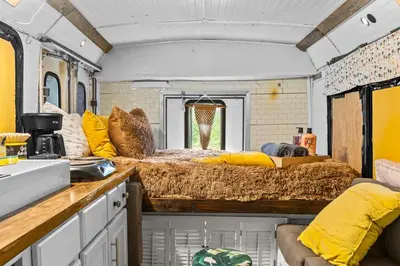 an interior view of an rv with hay on the counter at Covered Bridge Tiny Home Bus On The Water In Rrg in Stanton