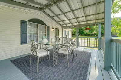 a patio with a table and chairs on a porch at Well and Cellar Near Kanawha River and ATV Trails!