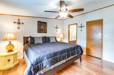 a bedroom with a bed and a ceiling fan at Well and Cellar Near Kanawha River and ATV Trails!