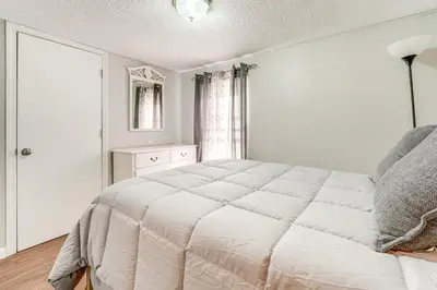 a white bedroom with a large bed and a window at Well and Cellar Near Kanawha River and ATV Trails!