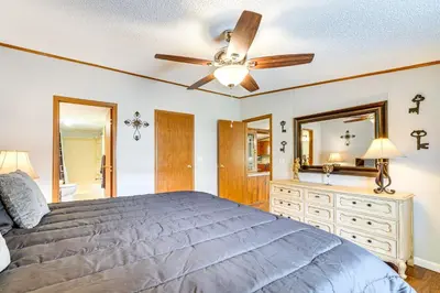 a bedroom with a bed and a ceiling fan at Well and Cellar Near Kanawha River and ATV Trails!
