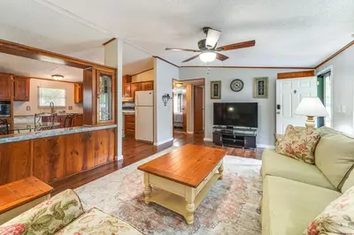 a living room with a couch and a table at Well and Cellar Near Kanawha River and ATV Trails!