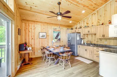 a kitchen with a table and a ceiling fan at Walk to Lake Kelleys Island Gem with Deck! in Kelleys Island
