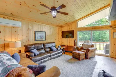 a living room with a couch and a ceiling fan at Walk to Lake Kelleys Island Gem with Deck! in Kelleys Island