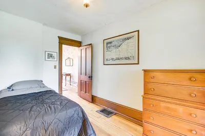 a bedroom with a bed and a dresser at 2 Mi to Chardon Square Spacious Farmhouse in Concord