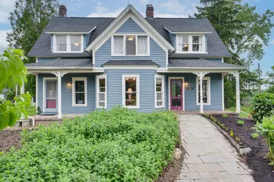 a blue house with a purple door at 2 Mi to Chardon Square Spacious Farmhouse in Concord