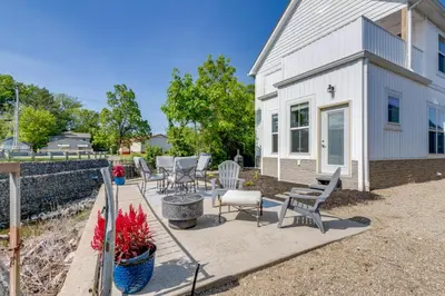 a patio in front of a white house at Steps to Buckeye Lake Family-Friendly Home in Buckeye Lake
