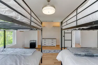 two bunk beds in a room with a window at Steps to Buckeye Lake Family-Friendly Home in Buckeye Lake