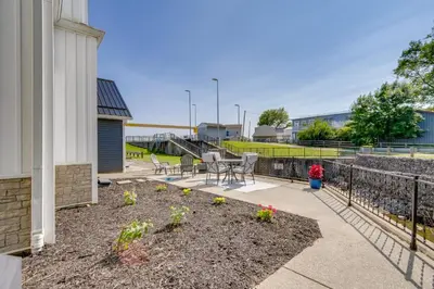 a patio with a table and chairs next to a fence at Steps to Buckeye Lake Family-Friendly Home in Buckeye Lake
