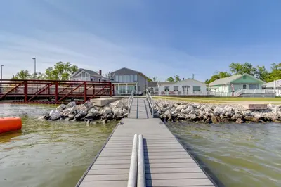 a group of birds on a dock in the water at Steps to Buckeye Lake Family-Friendly Home in Buckeye Lake