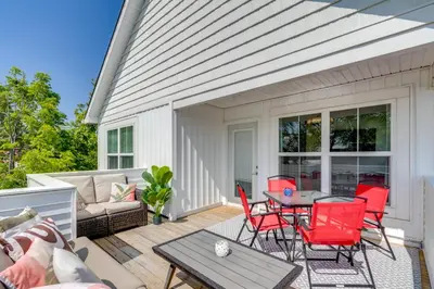 a patio with red chairs and a table at Steps to Buckeye Lake Family-Friendly Home in Buckeye Lake
