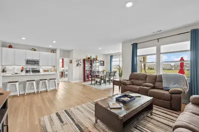 a living room with a couch and a table at Modern, newer home, King bed, near Indianapolis in Pendleton