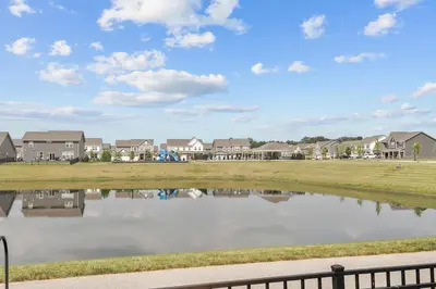 a view of a pond in a subdivision with houses at Modern, newer home, King bed, near Indianapolis in Pendleton